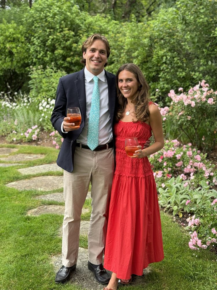 In a garden, drinks in hand