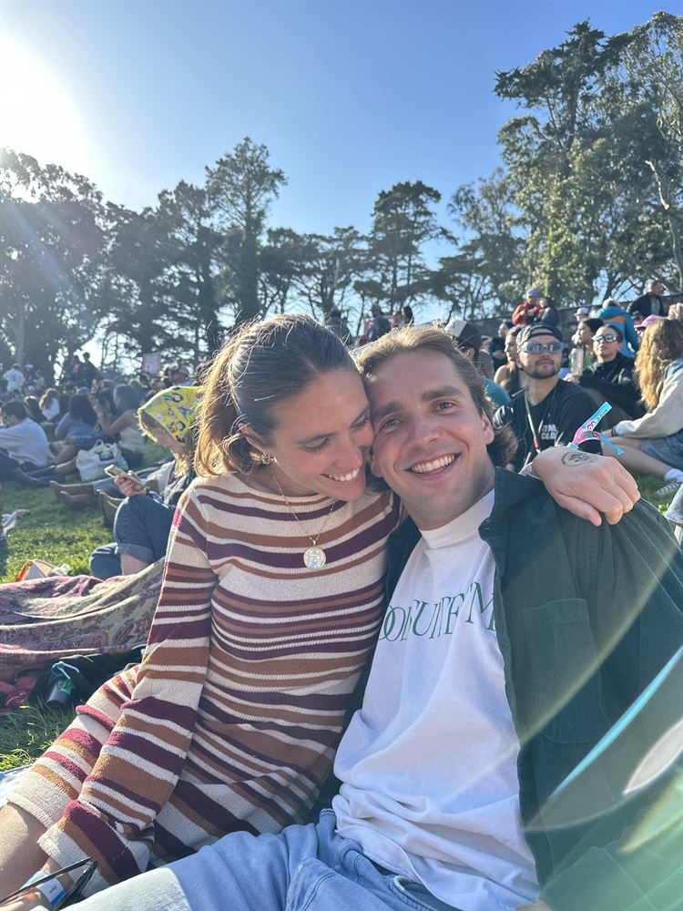 Sitting on the grass at an outdoor music festival