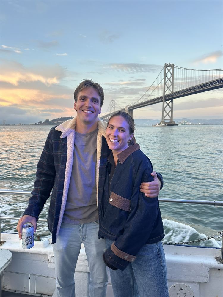 On a boat on San Francisco Bay with the Bay Bridge behind them